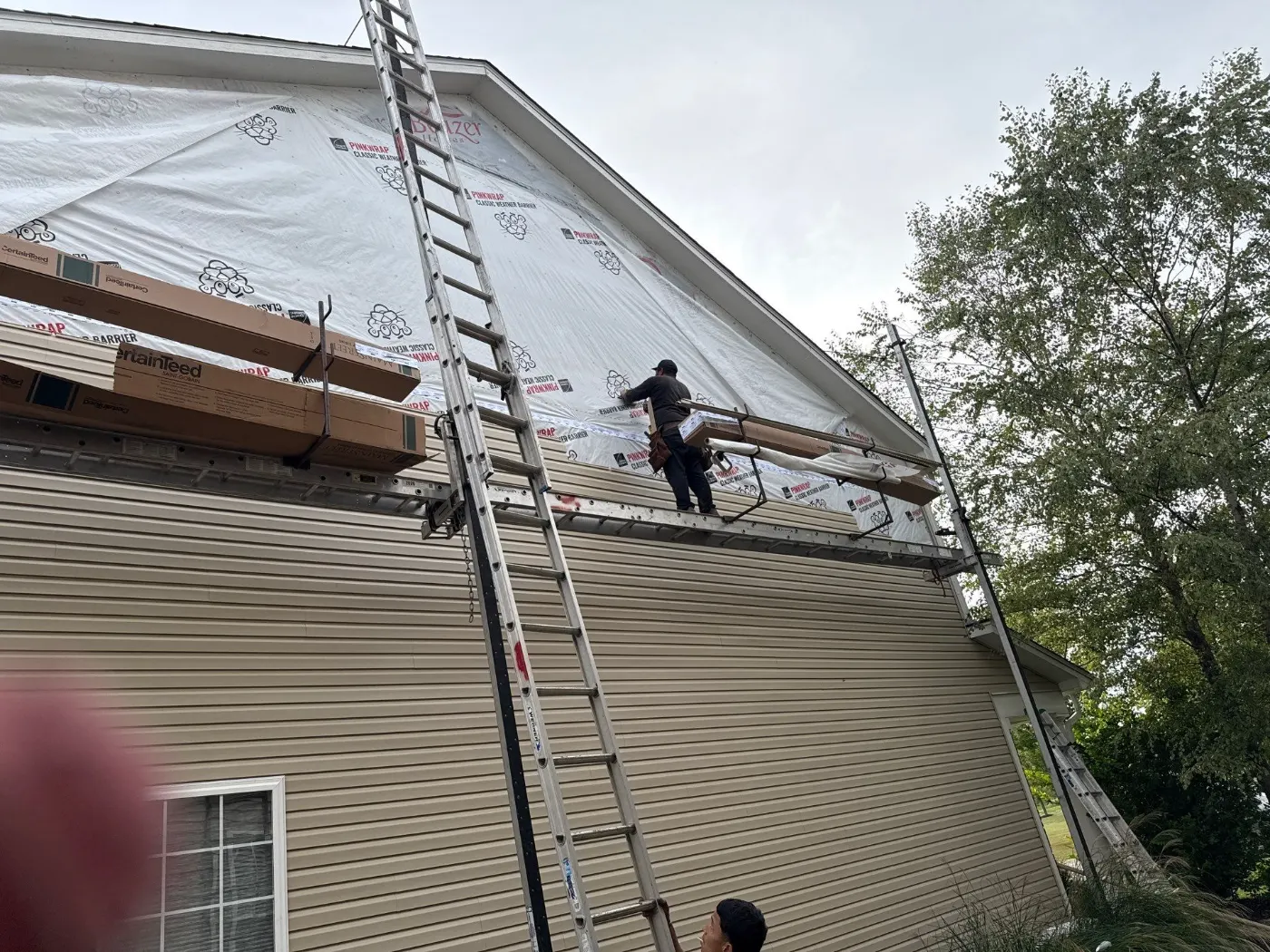 Siding installation documented in Bridlewood